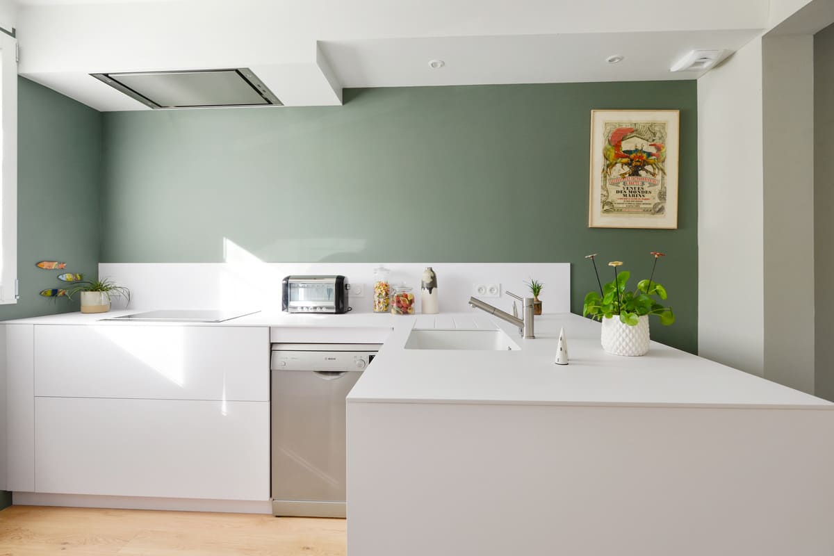 Cuisine moderne blanche avec mur vert émeraude à Nantes | Raison Home
